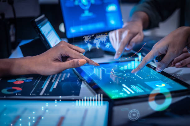 close up hand team of financial discussion fintech technology planning, analyzing digital financial data and strategy in a modern office at night