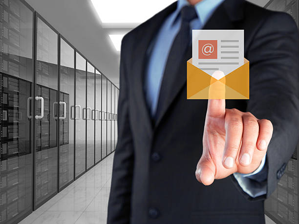 Businessman pressing button on touch screen interface and selecting mail icon Businessman pressing button on touch screen interface and selecting mail icon