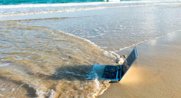 Sea water washing away a laptop. Sea water washing away a laptop.