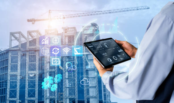 Hands using digital tablet with Construction Management Software on blurred construction site as background